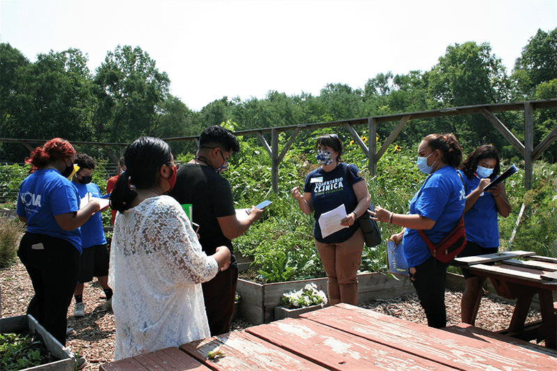 seven people gathered at an outdoor classroom