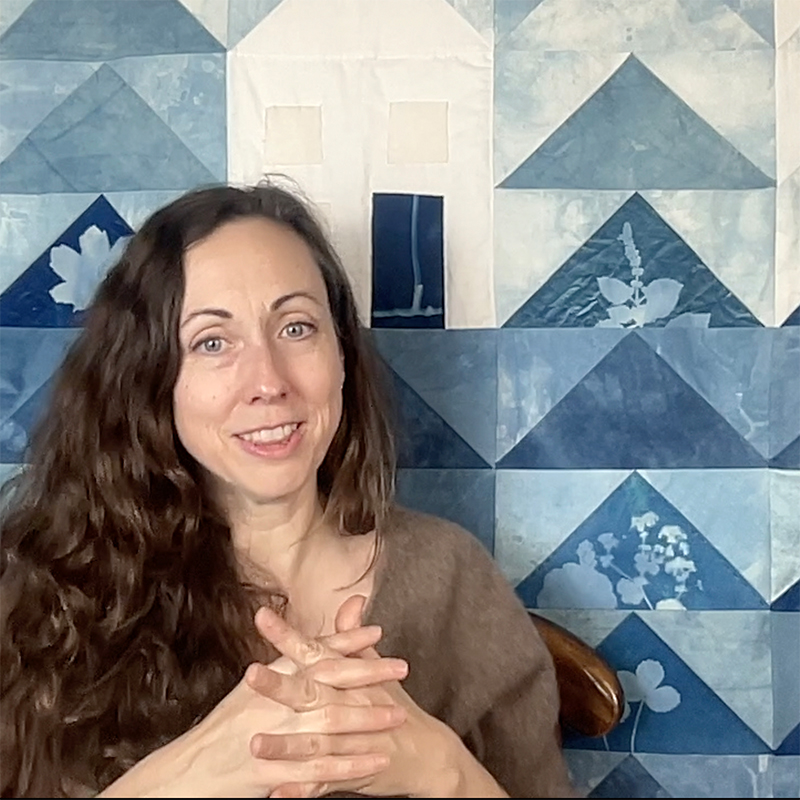 Lily Arati Michaud headshot with quilt